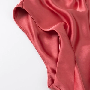 Detail of rose red satin fabric showing smooth silk texture and soft elegant drapes