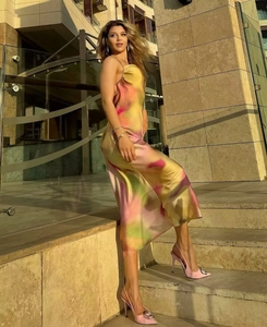 Detailed shot of a backless tie-dye satin dress with pink and green marble patterns