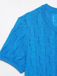 Close-up of bright blue cable knit short sleeve top showing ribbed collar and wavy texture