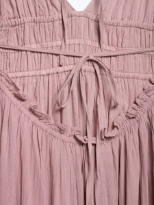 Detail of smocked waist with drawstring and ruffles on a dusty pink summer midi dress