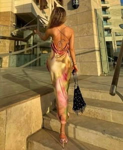 Detail view of floral satin backless dress featuring cross-strap ties and cowl back design