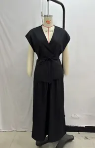 Detail view of black V-neck sleeveless wrap top and wide-leg trousers two-piece set