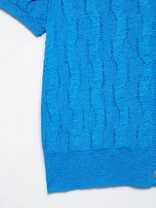 Detail of blue short-sleeve knitwear showing wave texture, hollow design, and white button
