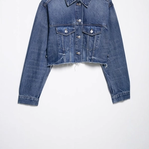 Women's cropped dark wash denim jacket with frayed hem and classic metal buttons