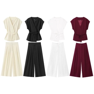 Flat lay of sleeveless V-neck tie tops and high-waist wide-leg pants in four colors
