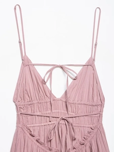 Detail of dusty pink tulle dress with adjustable thin straps and bow-tie neckline