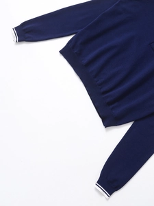 Détail du haut en tricot bleu marine avec poignets côtelés et rayures blanches