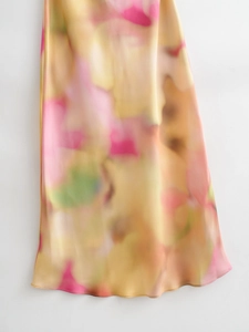 Detailed view of tie-dye satin maxi skirt featuring vibrant floral prints and silky texture