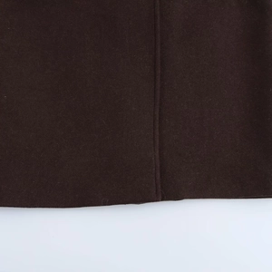 Detailed close-up of dark coffee wool fabric showing stitching and premium texture