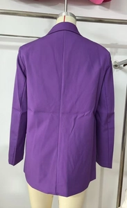 Detail view of the back seams and smooth woven fabric on a purple double-breasted blazer