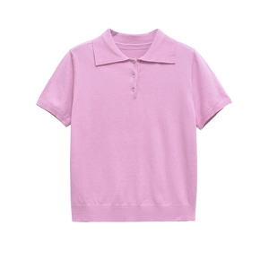 Close-up of pink knit polo shirt featuring pearlescent buttons and ribbed texture details