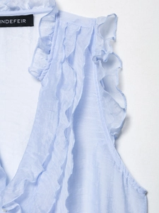 Detail of light blue sleeveless chiffon top featuring ruffled layers and neck pleats