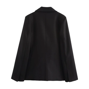 Rear view of slim fit black blazer with shoulder pads and single back vent detail