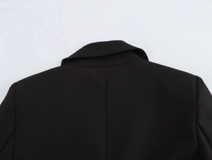 Detail view of the padded shoulders and notched lapel on this black slim blazer jacket