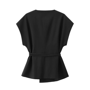 Back view of black sleeveless top with waist tie belt and irregular hem design