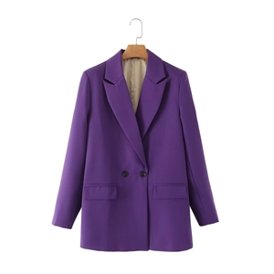 Detail view of double-breasted purple blazer with peak lapels and beige satin lining