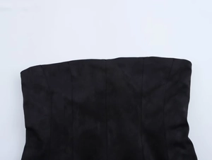 Detail of black strapless top showing matte fabric texture and vertical structural seams