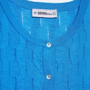 Women's bright blue cable knit short sleeve top with round neck and white buttons