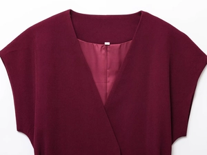 Detail view of burgundy sleeveless top featuring a deep V-neck and premium inner lining