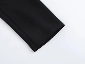 Detailed macro shot of high-quality black dense woven fabric texture and tight stitching