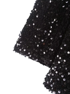 Close-up of black sequins sewn on velvet fabric for women's stylish blazer
