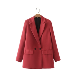 Detail of red double-breasted blazer with classic notched lapels and flap pockets