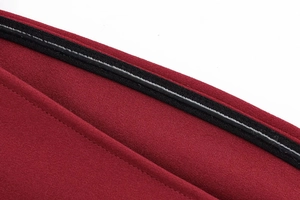 Detailed close-up of red fabric texture with black edge binding and white stitching