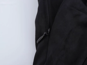 Detail of high-quality suede-like fabric with a sleek black metal teardrop zipper closure