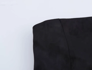 Detail of black suede fabric showing high-quality stitching and matte texture finish