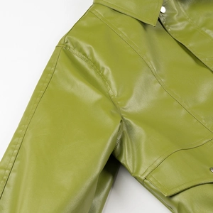 Detail of avocado green PU leather jacket showing lapel, metal snaps and fine stitching