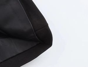 Close-up detail of reinforced seams and premium twill fabric on the sleeve cuff