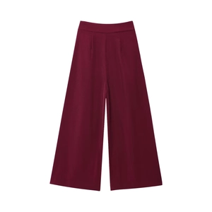 Detail of wine red high-waisted wide-leg trousers featuring pleated waist and silky finish