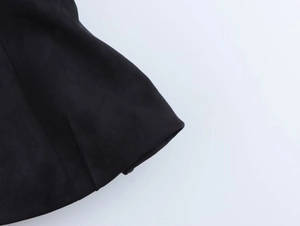 Close-up of black velvet texture and neat stitching on the hemline of the tube top