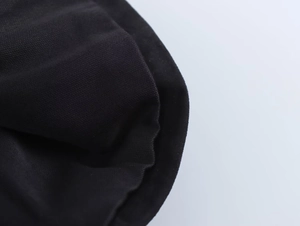Detailed macro view of the black velvet fabric texture and inner lining of the skirt top