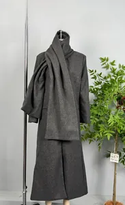 Dettaglio di un cappotto di lana grigio scuro con sciarpa larga abbinata per l'autunno