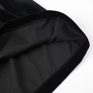 Macro shot of high-quality sewing and hem finish on a black velvet dress for women