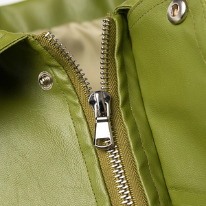 Detail of olive green leather jacket with silver metal zipper and snap button closure