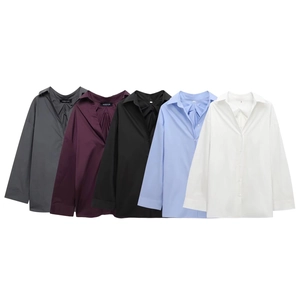 Flat lay of multiple classic long sleeve shirts showing color options and back pleats
