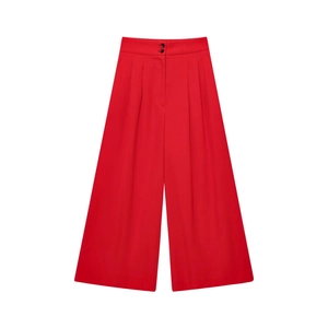 Detail view of high waist red wide leg trousers with double button closure and pleats