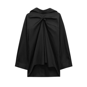 Detail of black long-sleeve shirt featuring back pleats and asymmetric high-low hem design