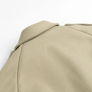 Close-up of lapel collar and premium wool texture on women's khaki autumn coat