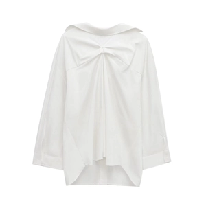 Detail of elegant twist knot design and draping texture on white long sleeve shirt