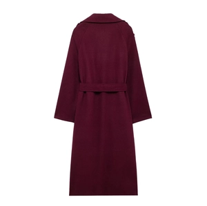 Detail view of the back of a burgundy long wool coat with matching waist belt for winter