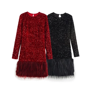 Detail of sequined party dresses with fluffy faux fur hem in red and black colors