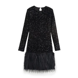 Close-up of black sequined dress with feather hem detail and round neckline texture