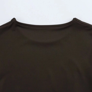 Close-up of the clean stitching and fine knitted texture on a dark long sleeve bodysuit
