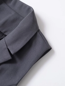 Detailed macro view of high-quality dark grey twill fabric and refined lapel stitching