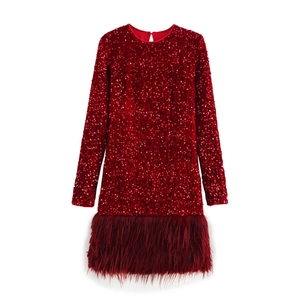 Detail of red sequin mini dress featuring elegant feather trim and a shimmering finish