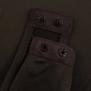 Detail of snap button closure and ribbed knit texture on dark brown bodysuit