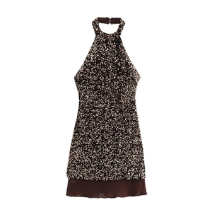 Close-up of champagne sequin halter mini dress with sheer chiffon hem detail